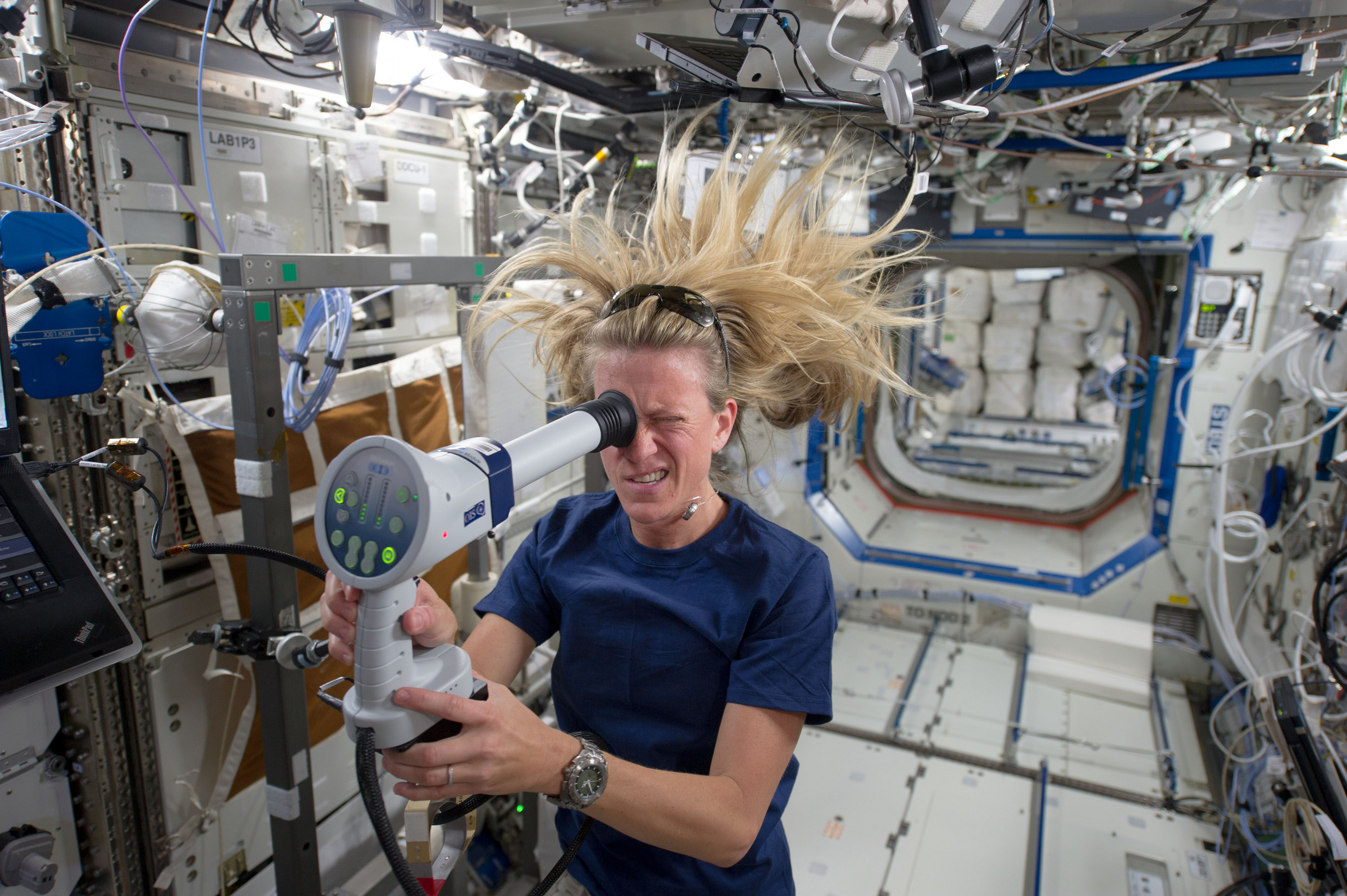 NASA astronaut Karen Nyberg of NASA uses a fundoscope to image her eye while in orbit. Photo by NASA