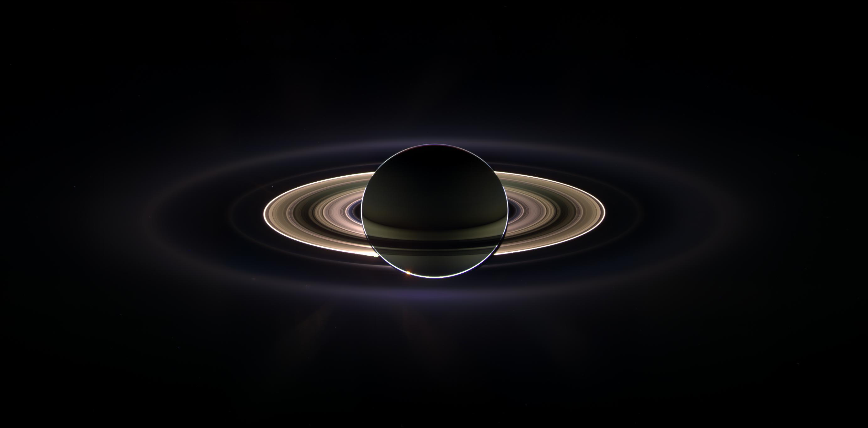 With giant Saturn hanging in the blackness and sheltering Cassini from the sun's blinding glare, the spacecraft viewed the rings as never before, revealing previously unknown faint rings and even glimpsing its home world. Credit: NASA/JPL/Space Science Institute