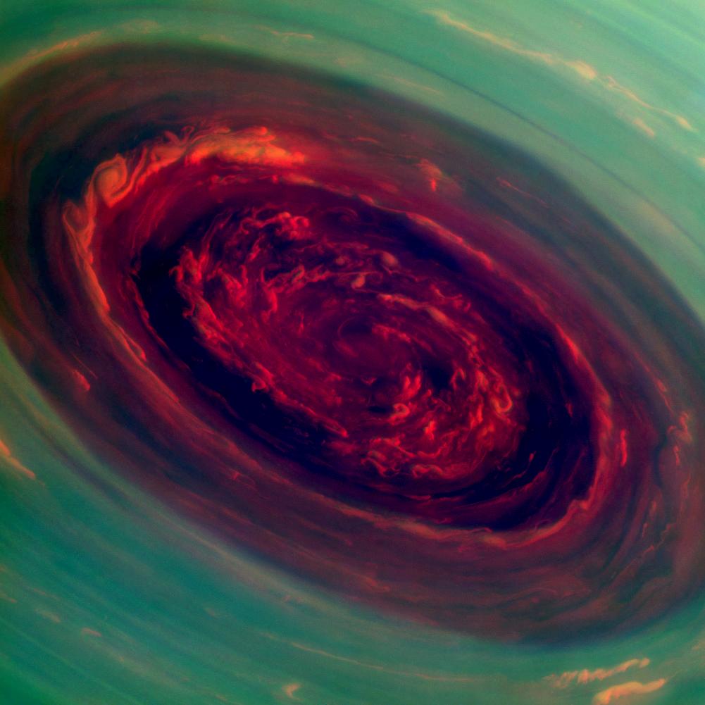 The spinning vortex of Saturn's north polar storm resembles a deep red rose of giant proportions surrounded by green foliage in this false-color image. Measurements have sized the eye at a staggering 1,250 miles across with cloud speeds as fast as 330 miles per hour. Credit: NASA/JPL-Caltech/Space Science Institute