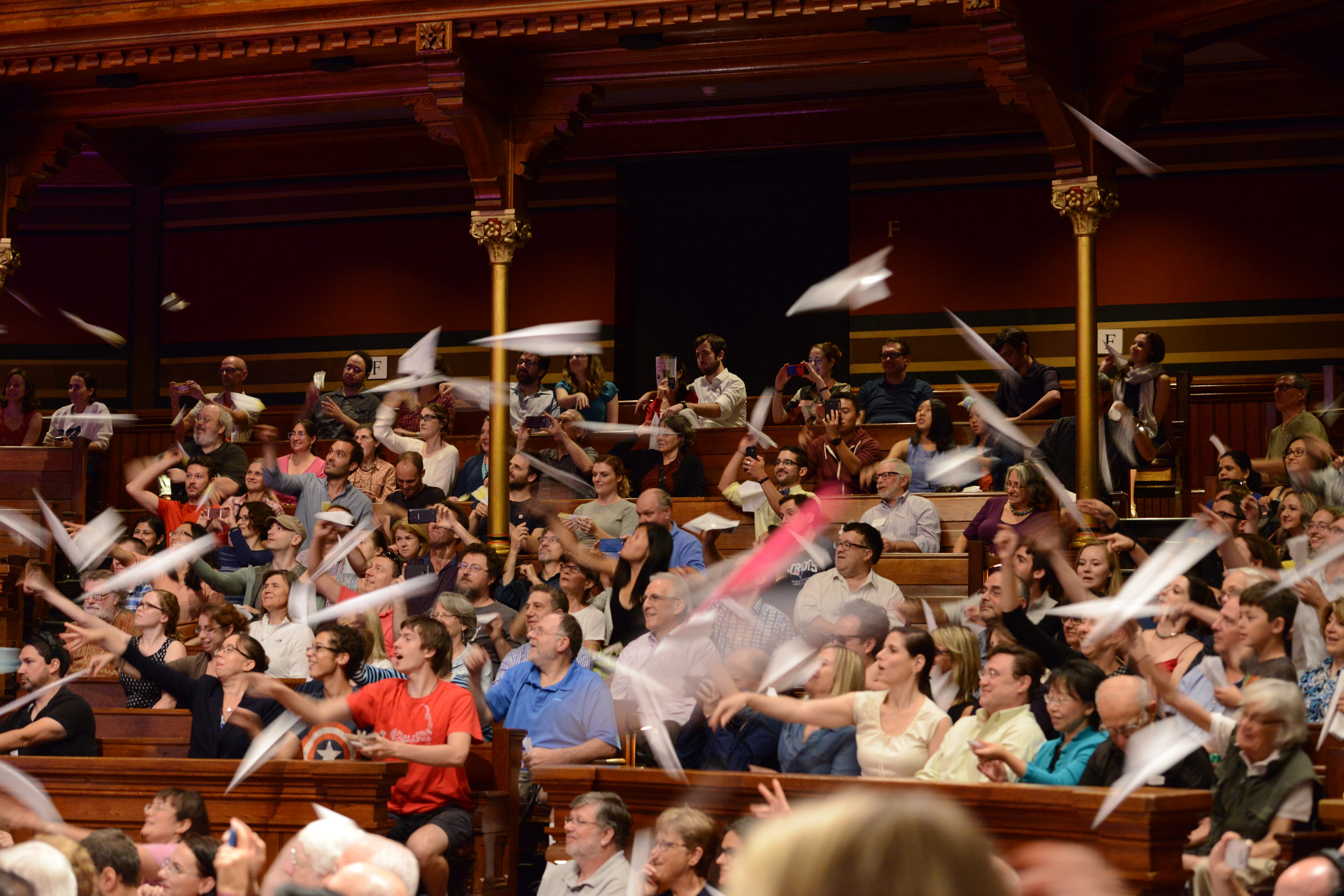 Paper airplanes are thrown by the audience. Credit: Mike Benveniste