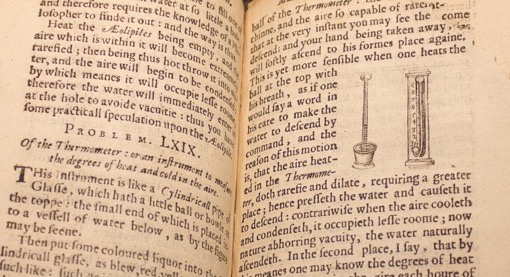 close up shot of a very old book with thermometer illustration and word
