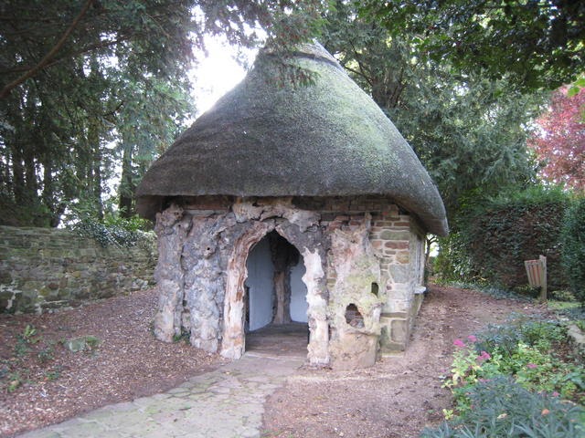 small hut made fo sticks and stones that looks like a smurf hut