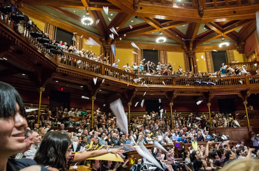 audience throwing paper airplanes