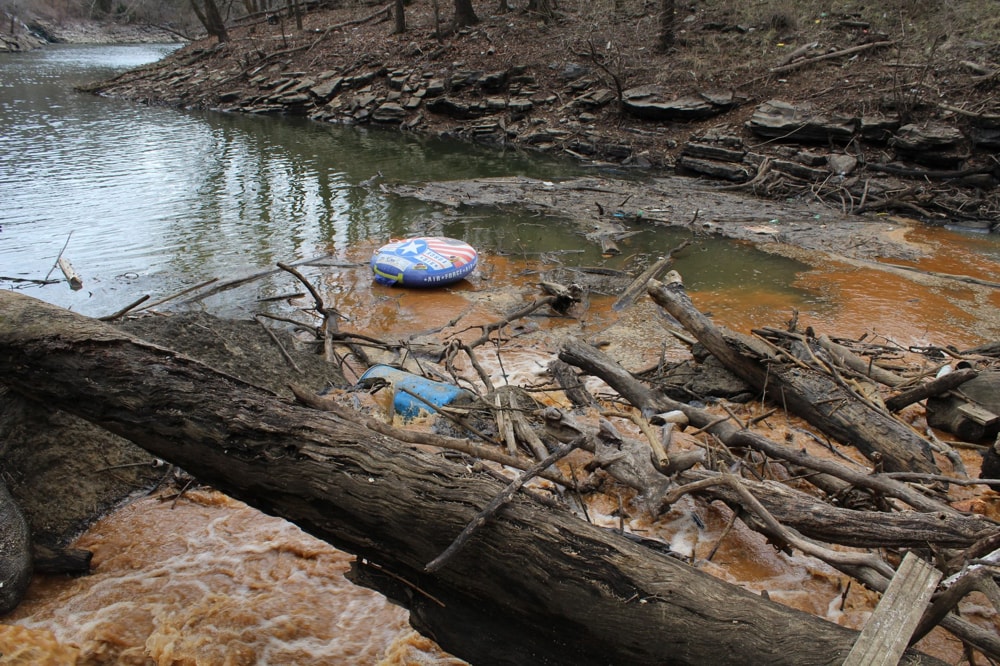 a lake with brown coal water seeping into it