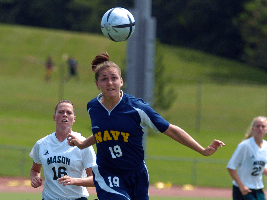 woman heading soccer ball