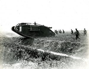 WWI tank in field with soldiers