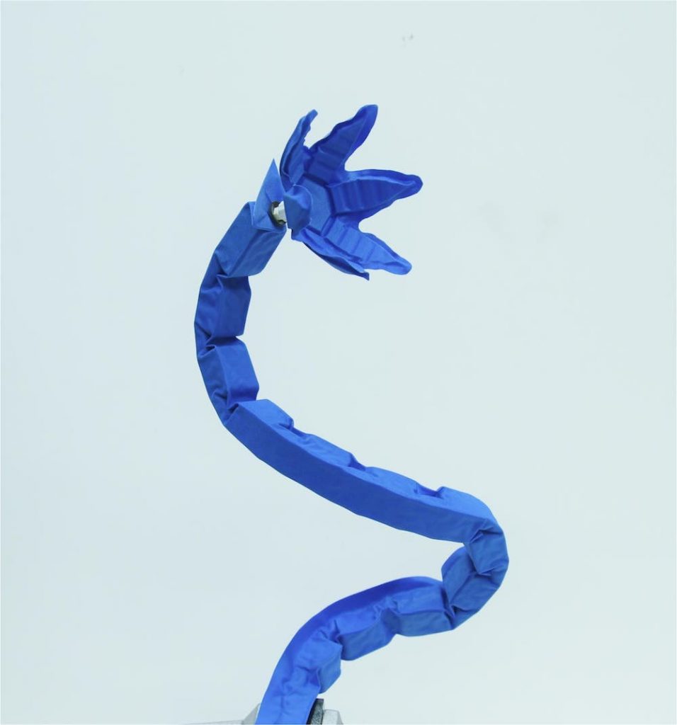 a blue thin arm with a robotic flower-shaped end