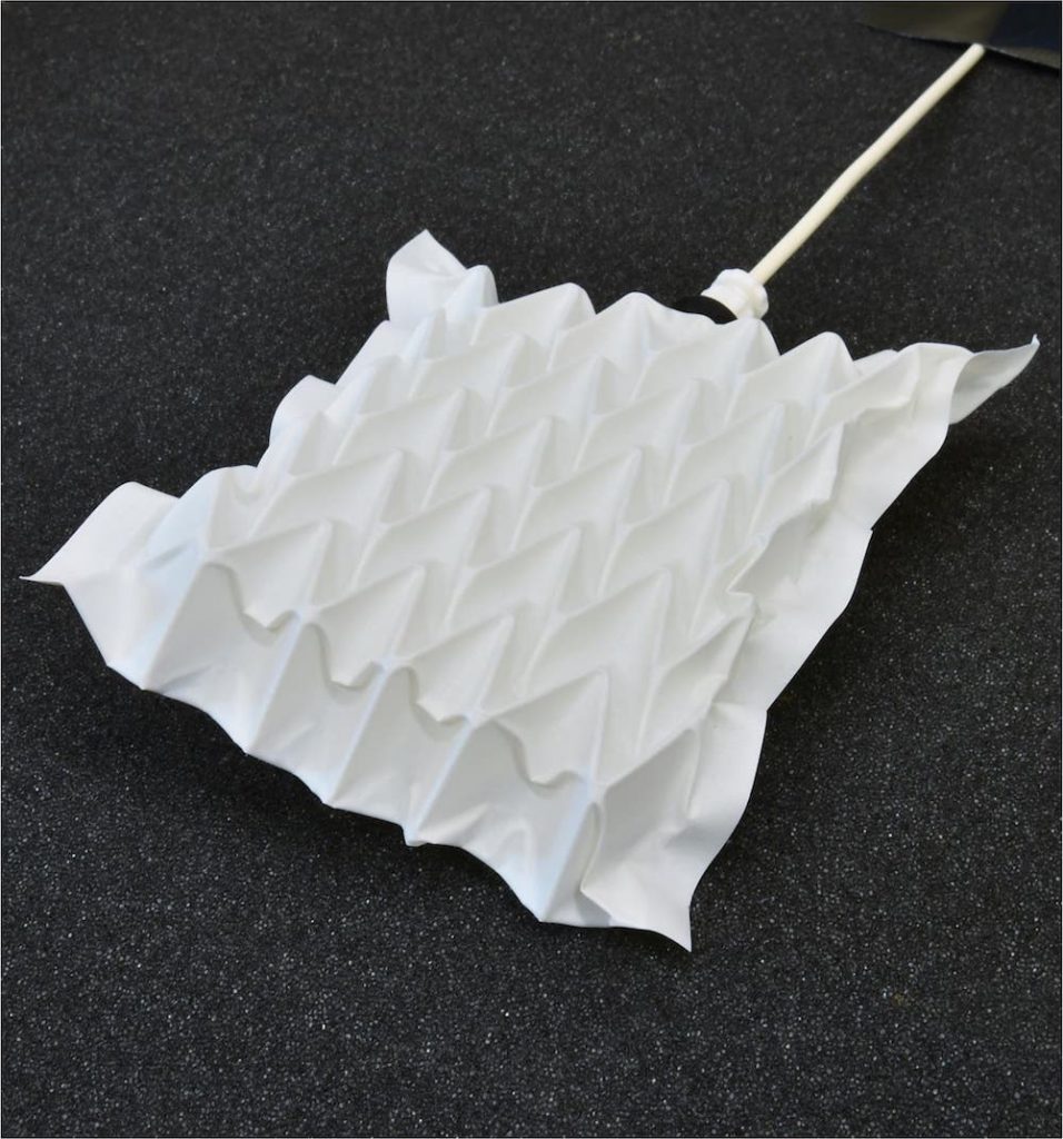 white robotic pad with geometric folds
