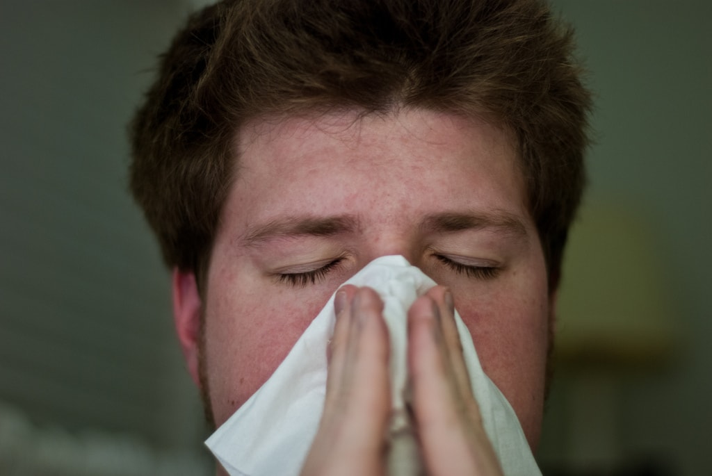 man blowing his nose