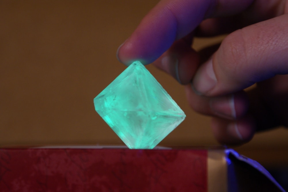 a crystal glowing green under UV light