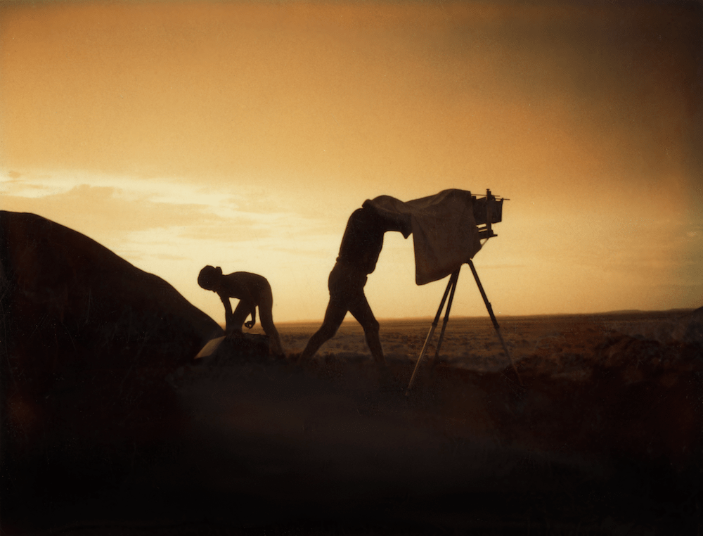 two filmmakers silhouetted at dawn 