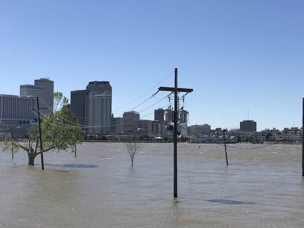 high water levels in new orleans, water is covering streets and surrounding electric poles