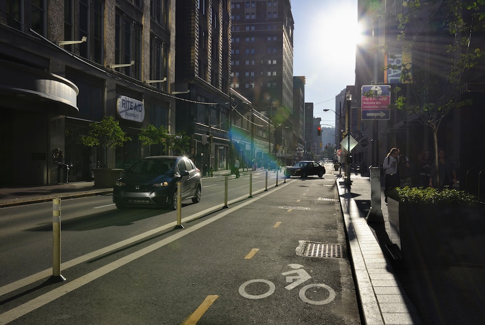 a street with a two-way bike lane on the right side of the road