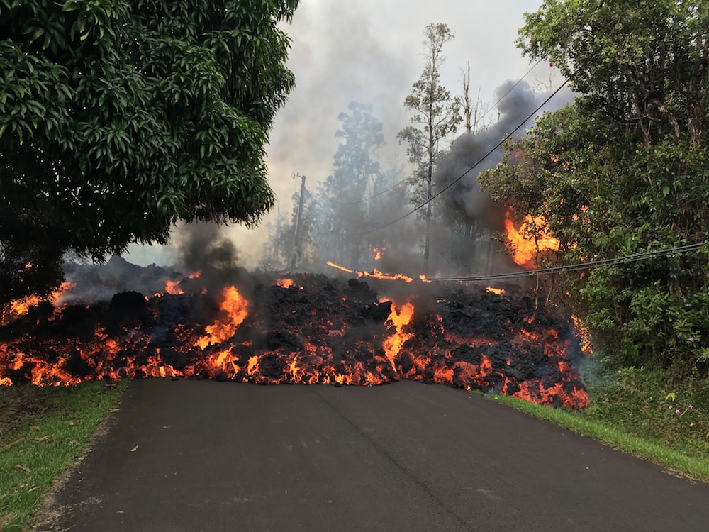 a short wall of lava consumes a street