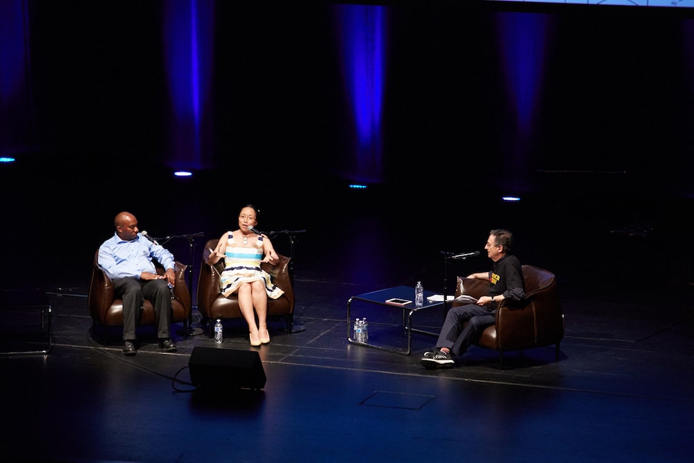 three people on stage including ira, eugenia cheng, and Edray Goins