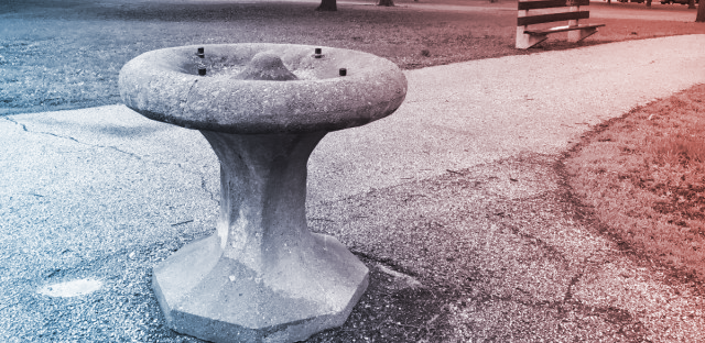 stone water fountain with red and blue filter overlaid