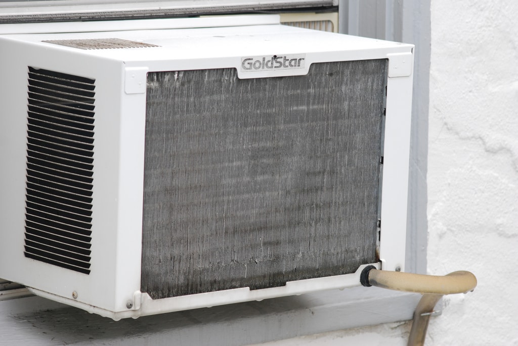 a dirty old air conditioner in a window