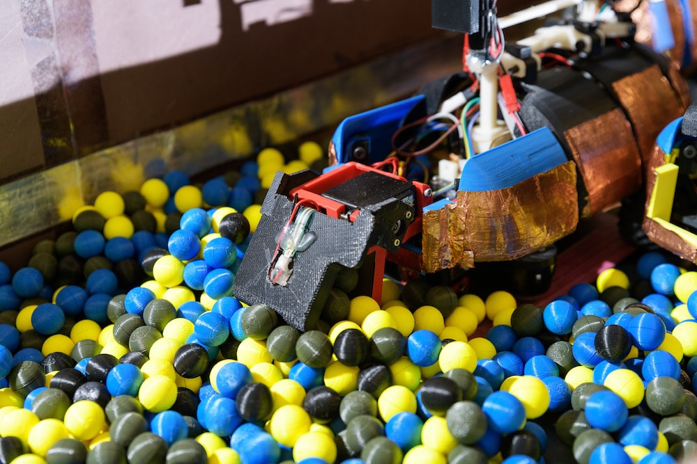 A robot ant in a pit of multicolored balls