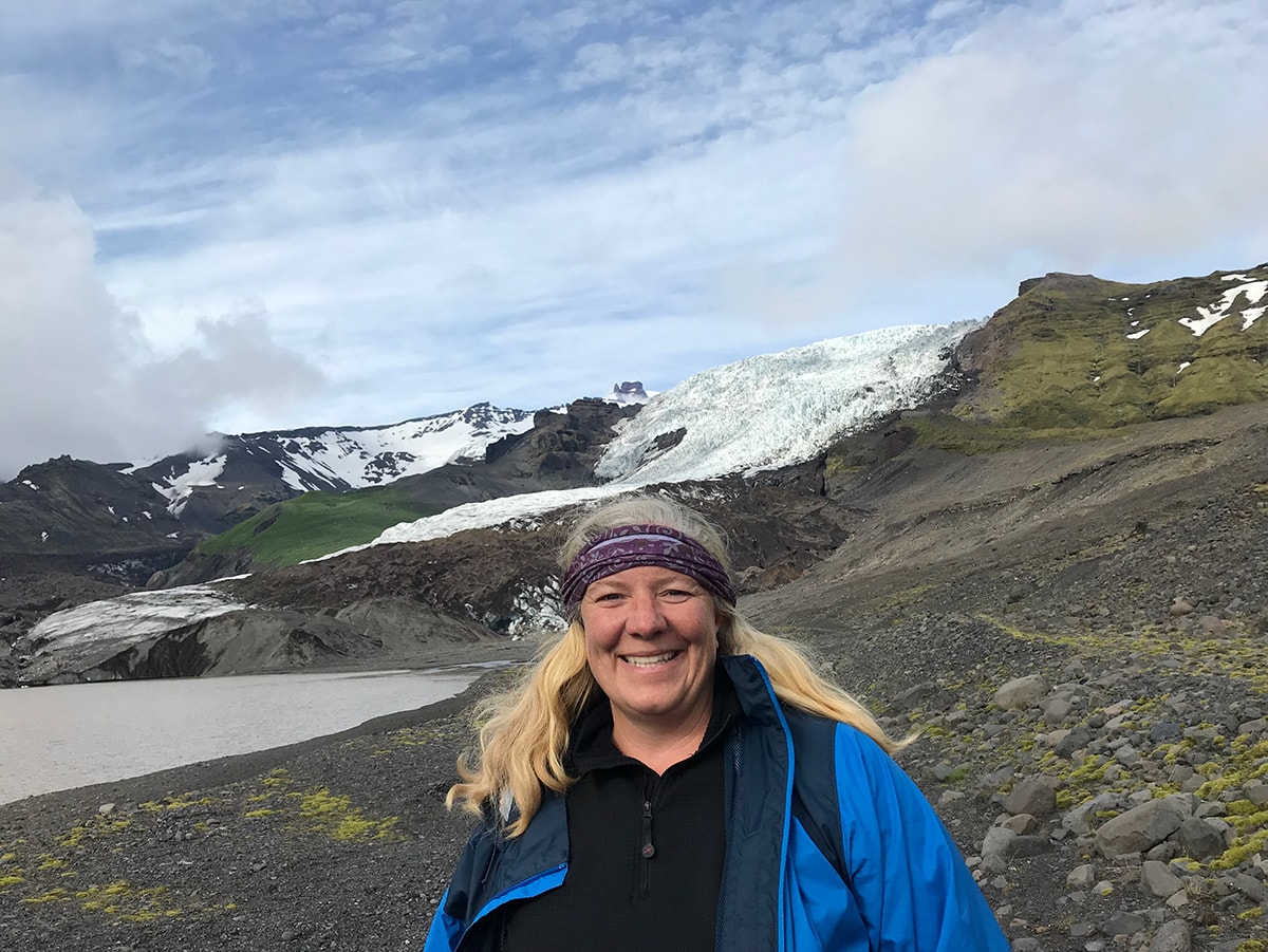 Katie Brown standing in front of a glacial mountainside. 