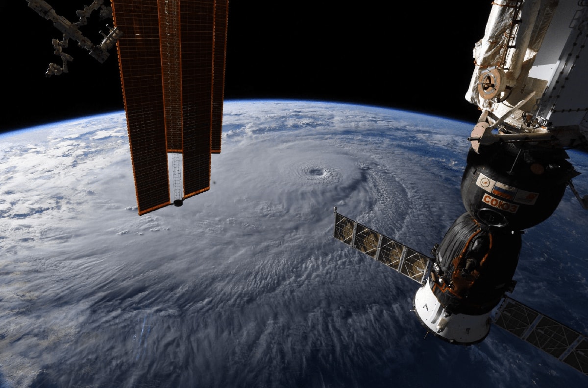 A massive hurricane seen from space, with portions of the International Space Station in the foreground