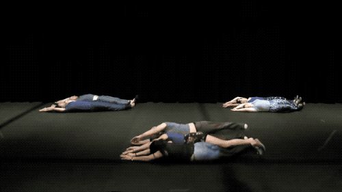 dancers rolling in tandem on the floor