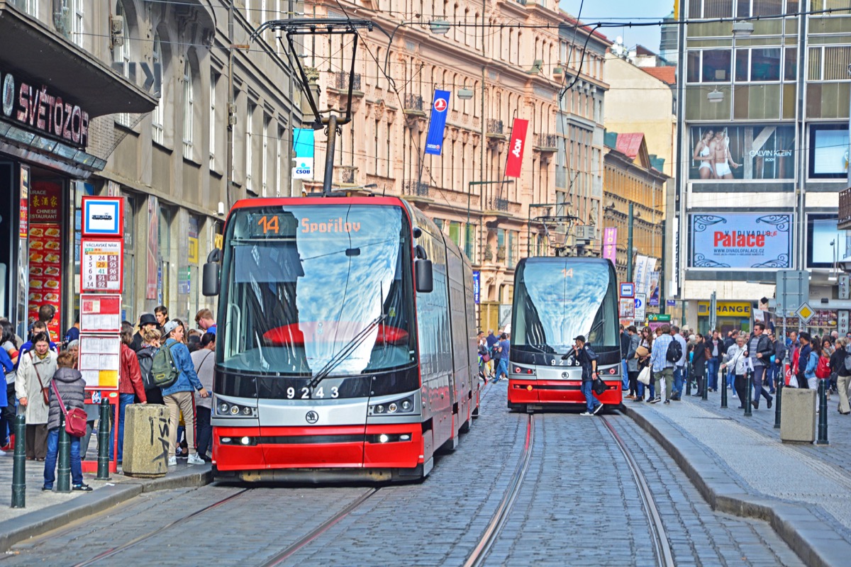 two trolleys going down a street, with a man dashing out in front of one in a way reminiscent of the trolley problem