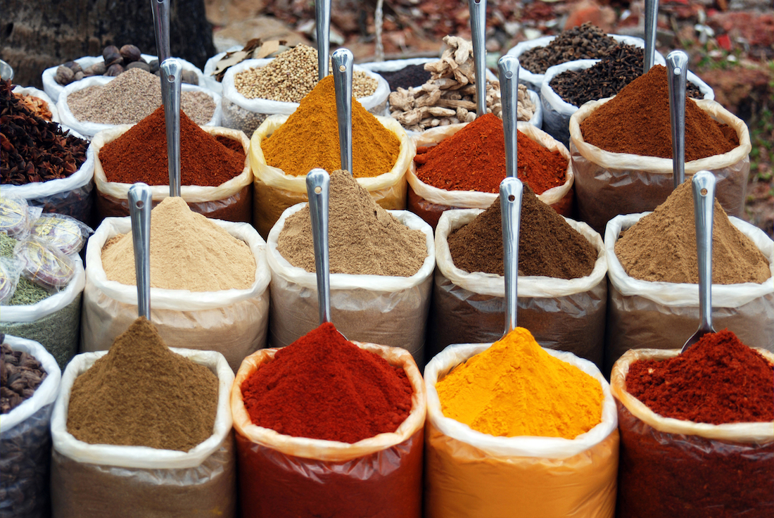 colorful spices in bags sitting in a row on display