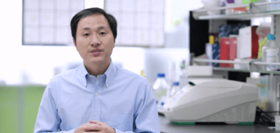 chinese scientist standing in front of lab equipment