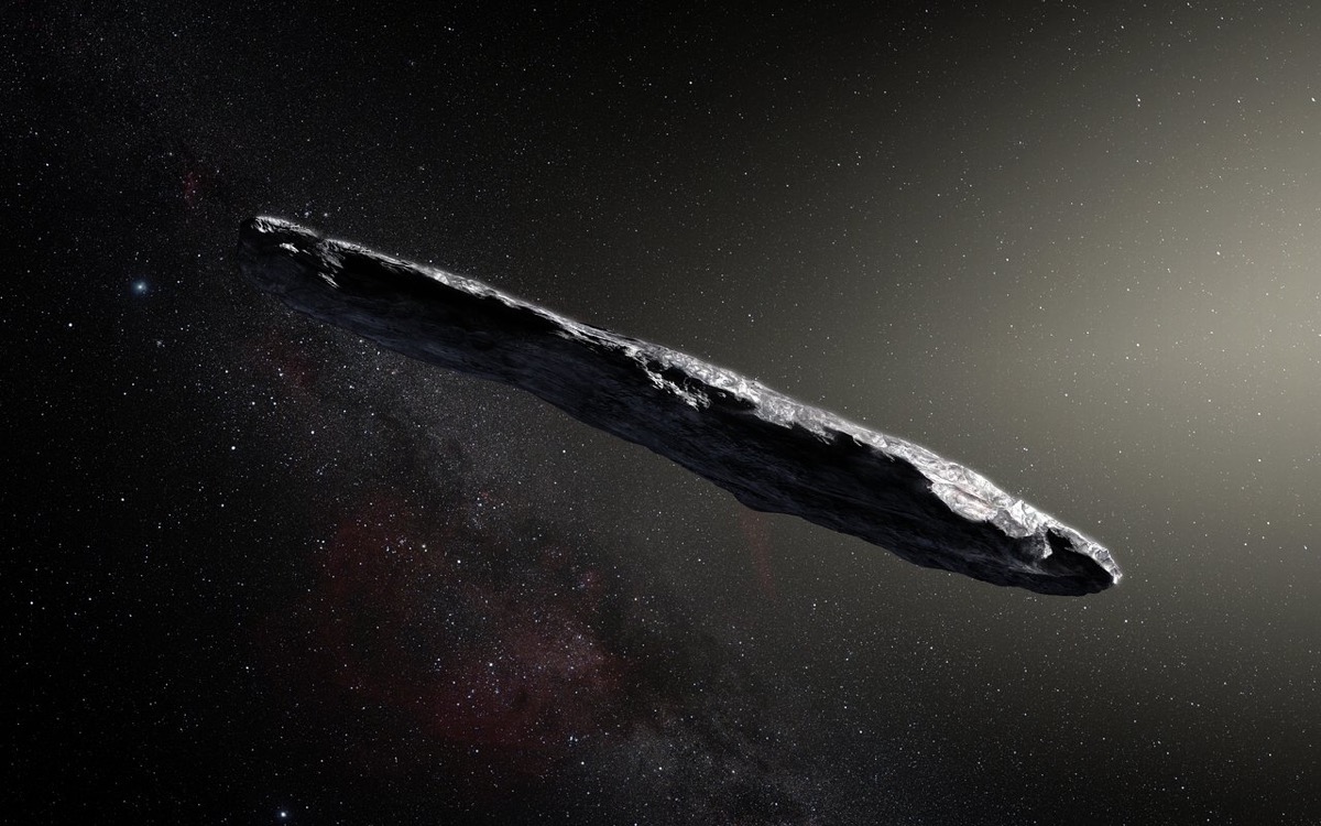 a cigar-like asteroid going through deep space