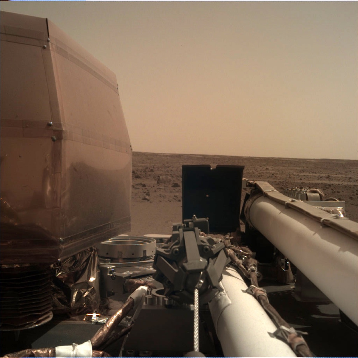 Lander arm underneath red martian sky