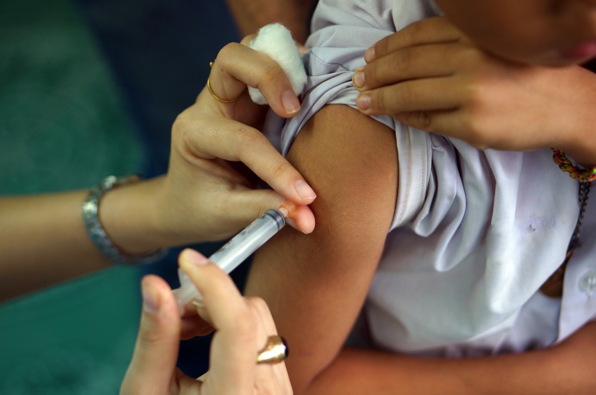 a calm child receiving a flu shot