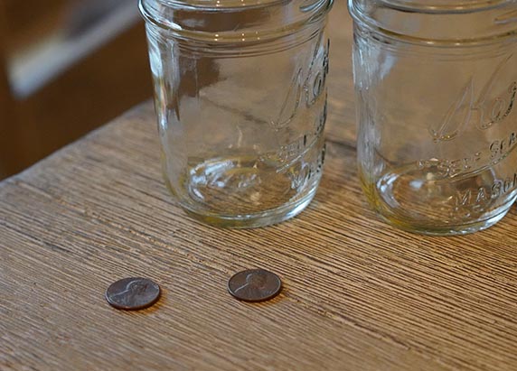 two dull pennies and two glass jars