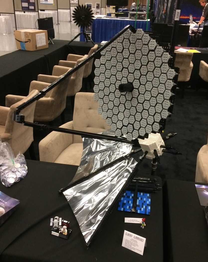 a lego model of the luvoir mirror on a conference table