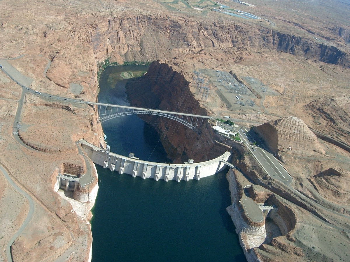 a dam from above, on one side the water is much lower than the other, with logo that says "state of science"