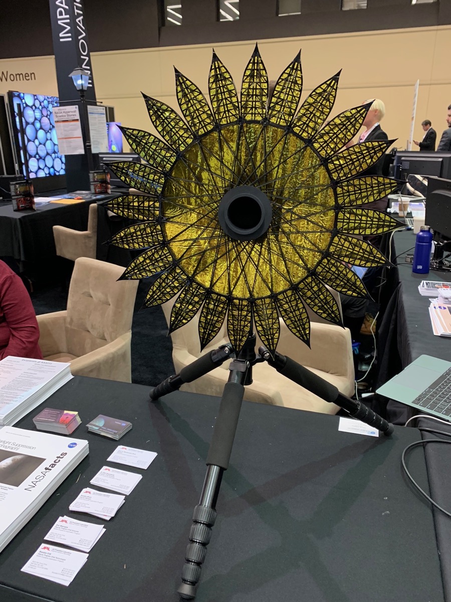 a golden shimery shade that looks like a more complicated umbrella unfolded and propped open on a table