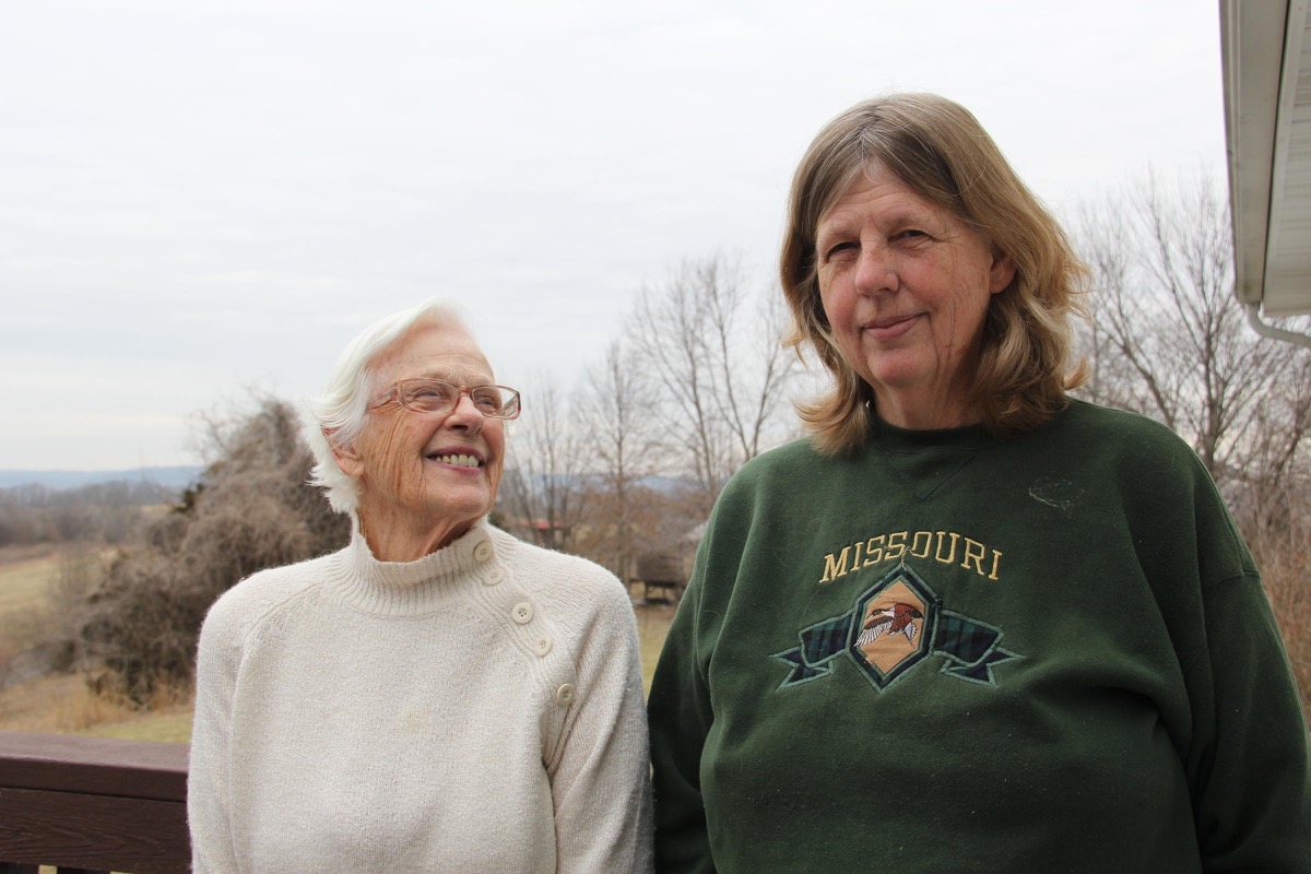 two women, one with white hair and glasses and another wearing a "missouri" sweater