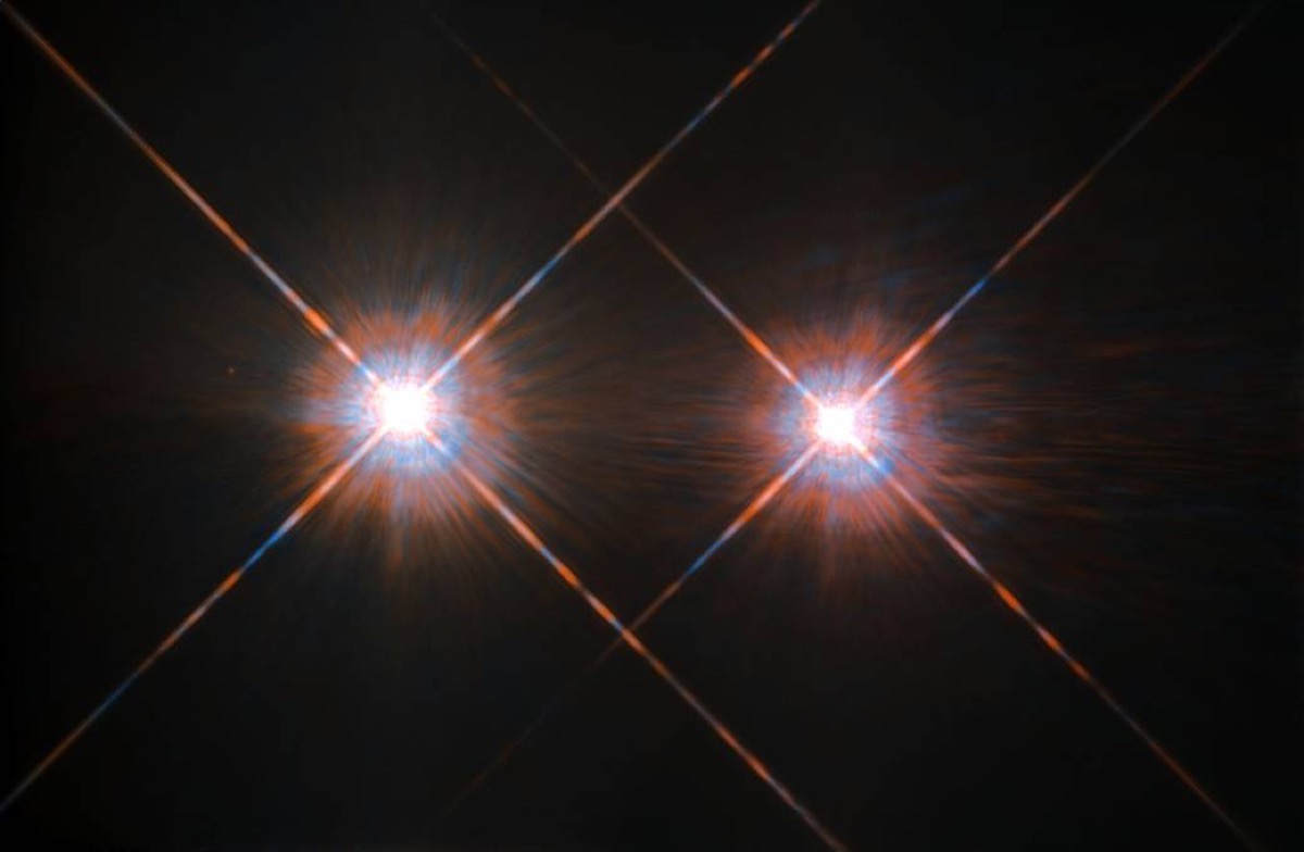 two bright glowing stars on a black background