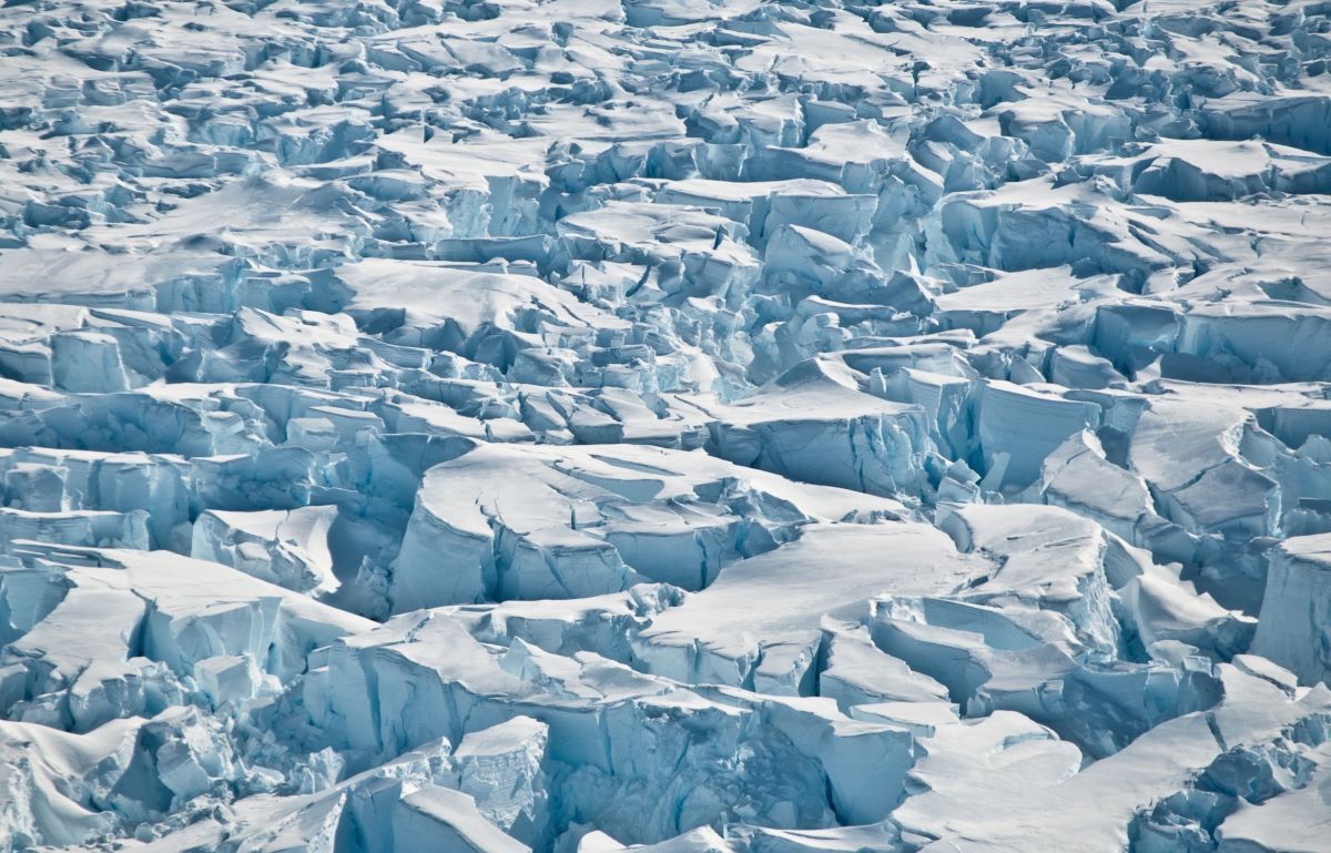 blue white ice that is completely etched with deep cracks