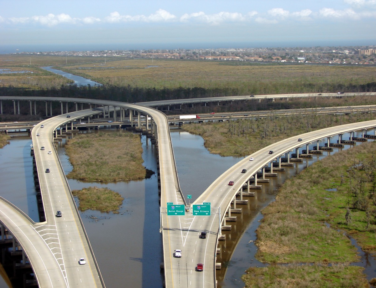 an interstate highway over wetlands. new orleans is in the background