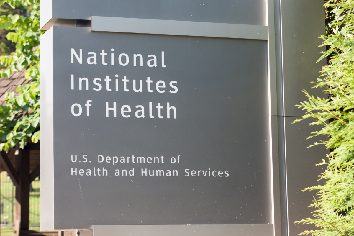 a grey sign stating the name of the national institutes of health outside washington dc