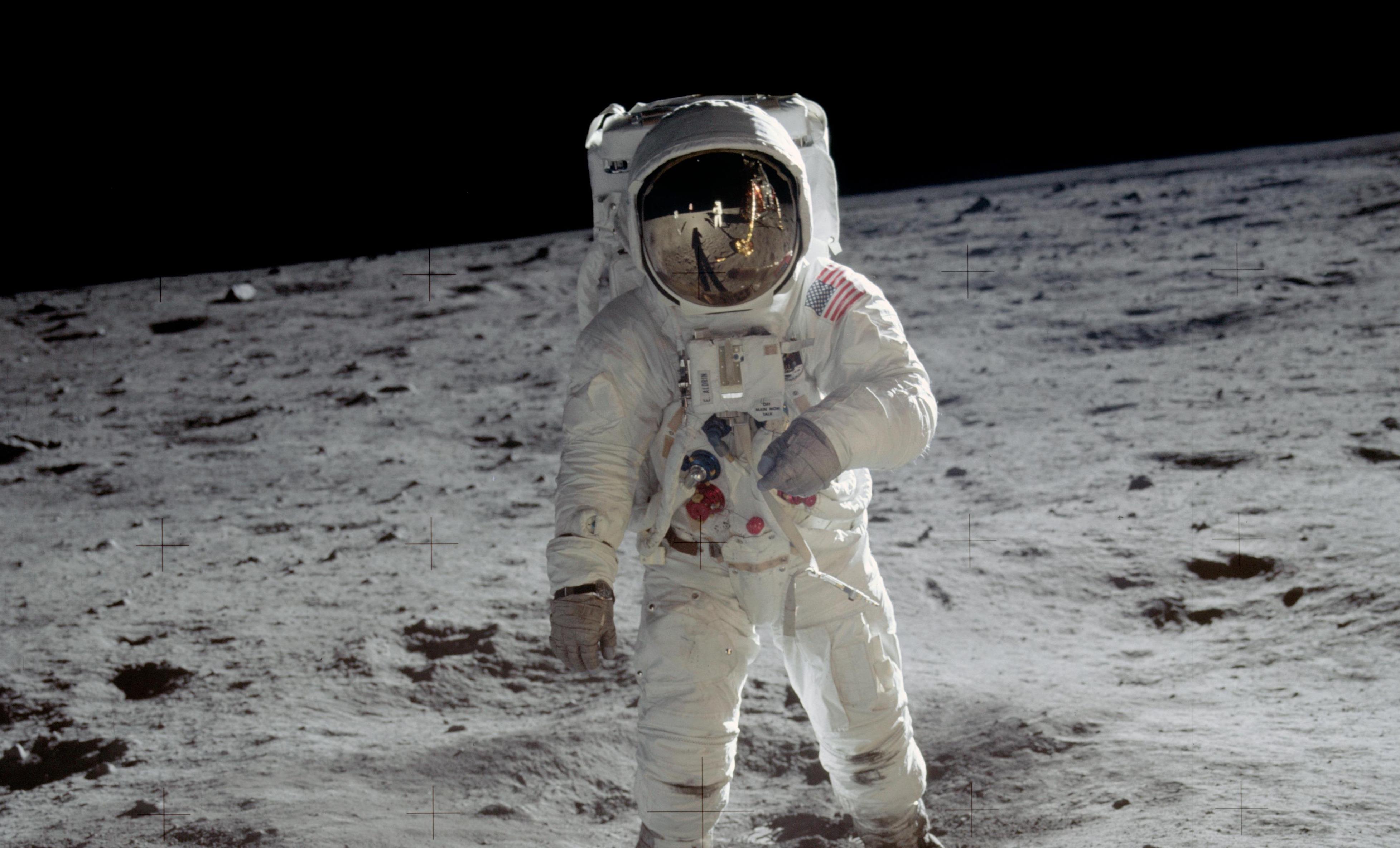 an astronaut stands on the moon
