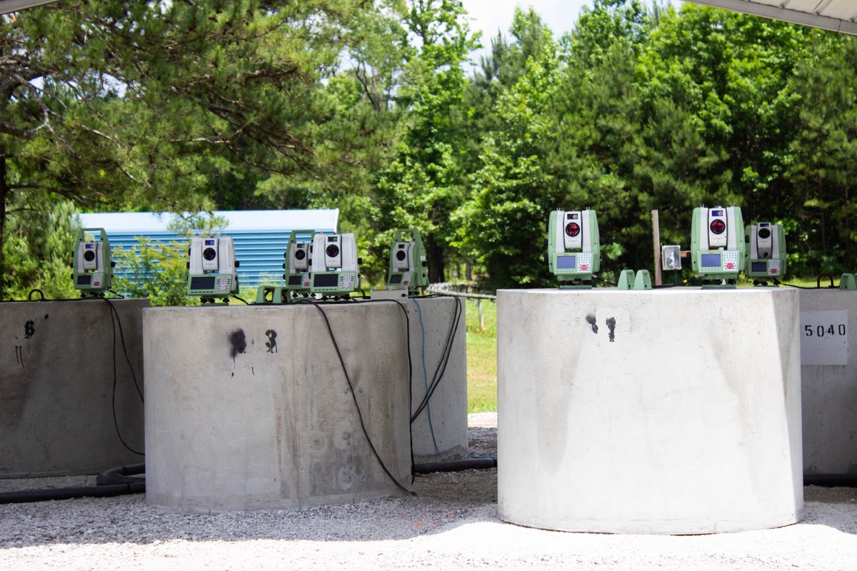 some laser equipment sitting on cement blocks on an outdoor launch facility