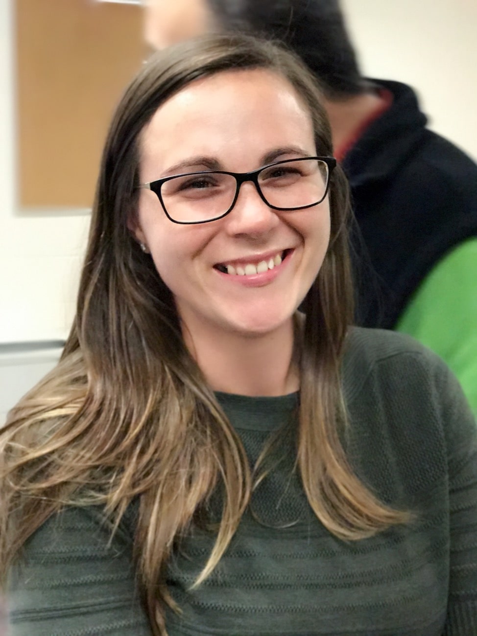 a woman smiling in a classroom