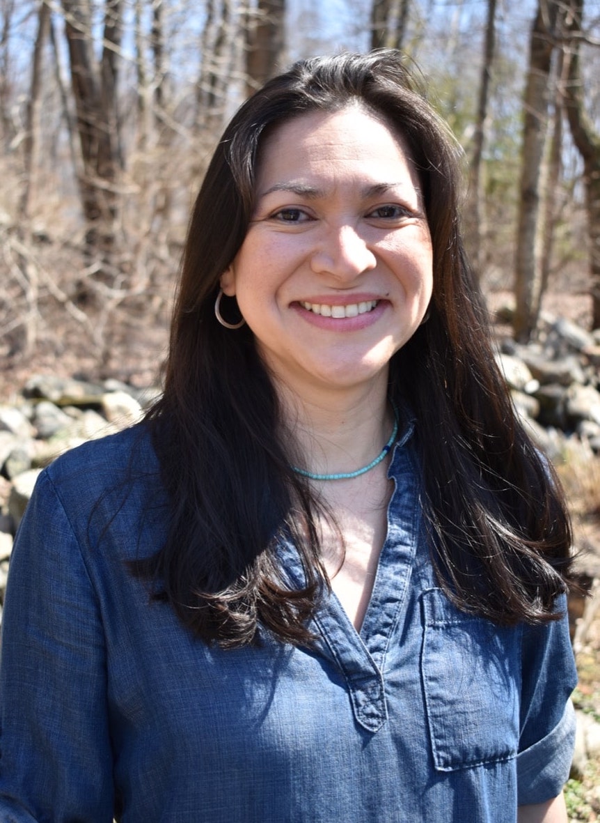 a woman standing in the forest