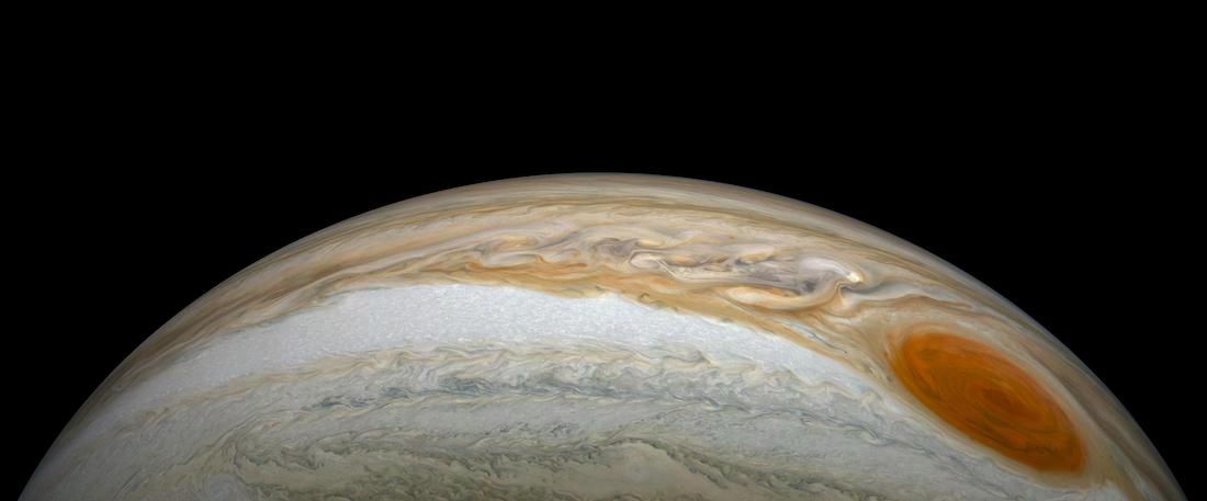 panoramic view of the swirls on jupiter with the great red spot, against a black background