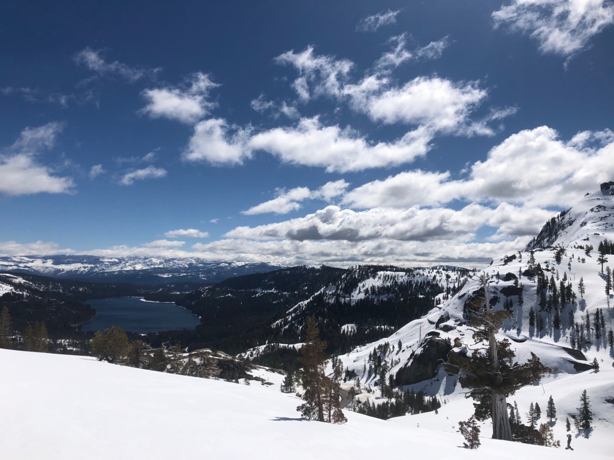 a photo of lake tahoe and the snowy mountains that surround it on a bright clear day