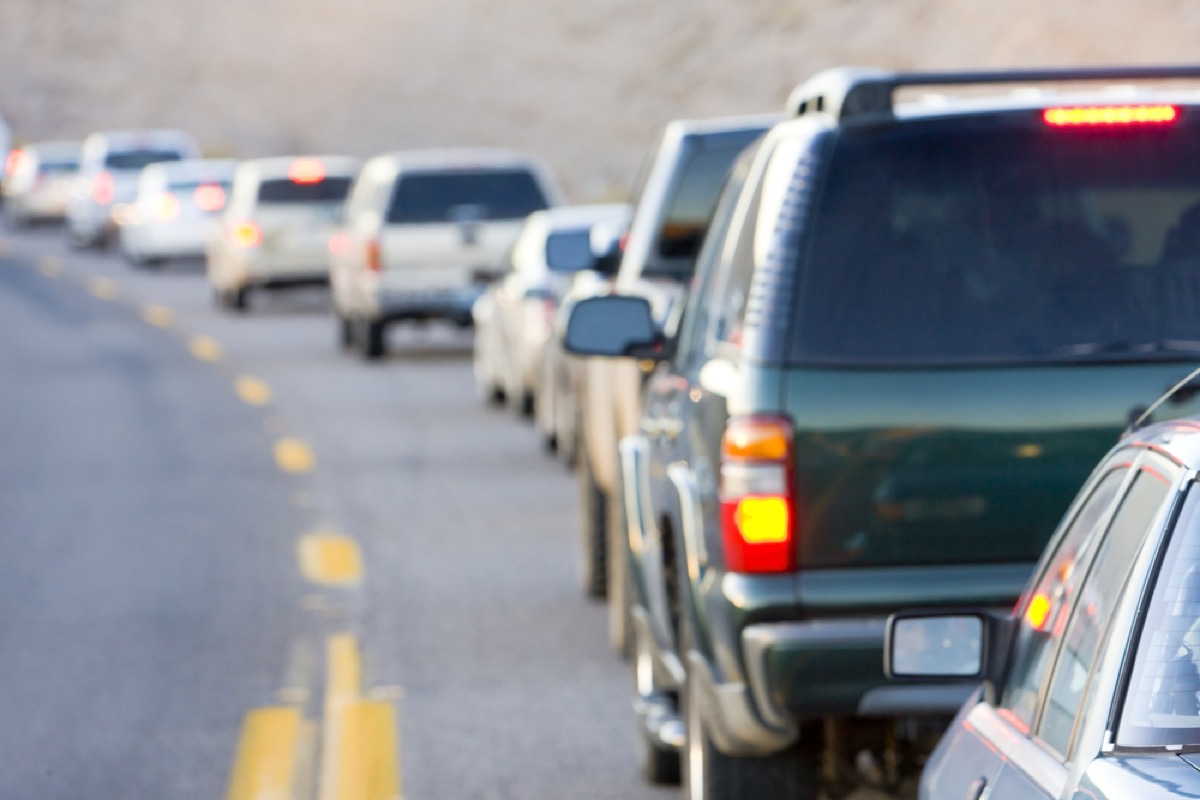 a line of cars on a road stuck in traffic