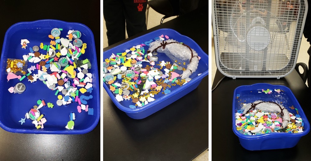 Blue bins with plastic bits testing ocean clean-up device model.