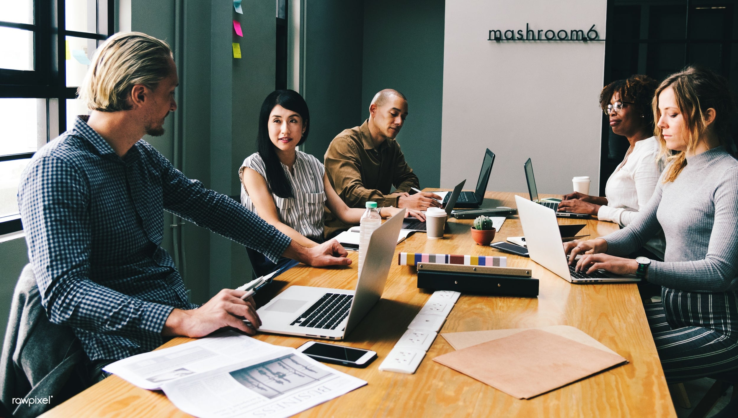 Group of people working around a desk