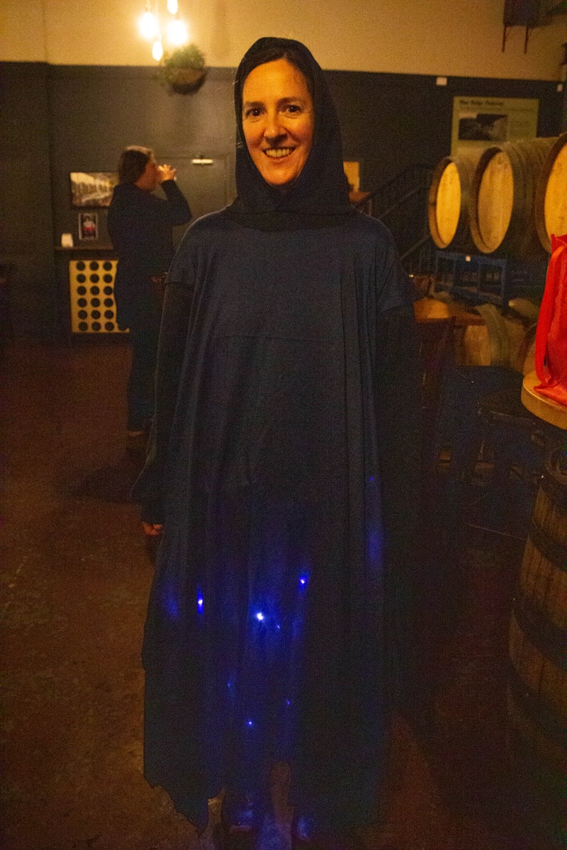 a woman in a blue sheet and blue lights represents a blue ghost firefly